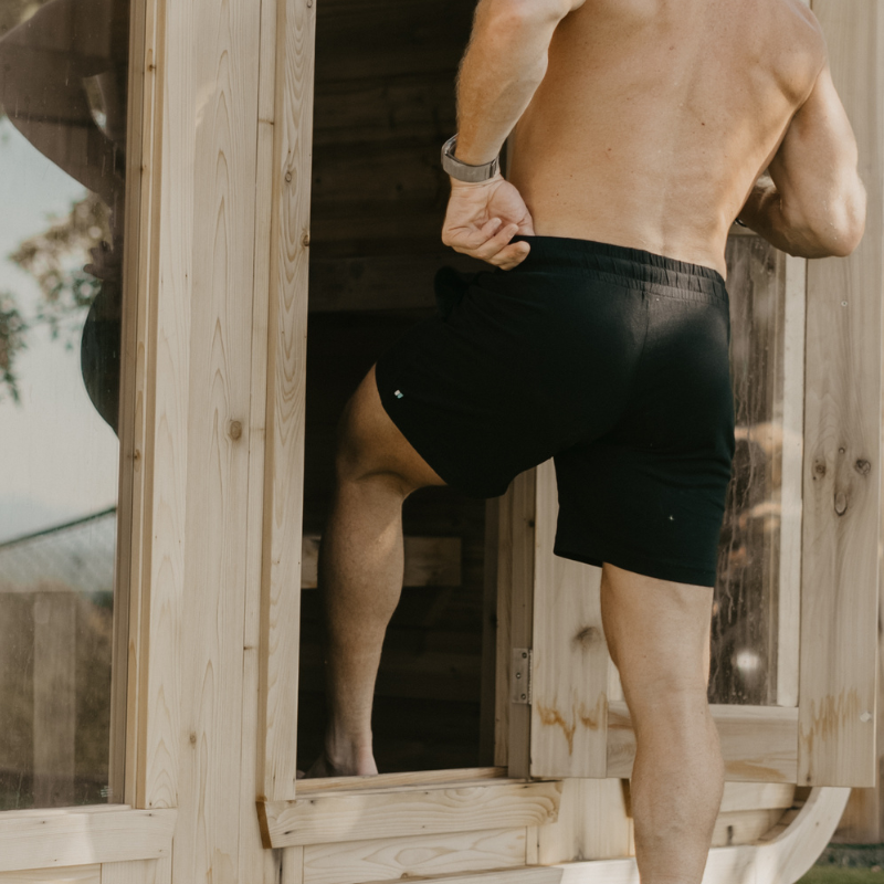 Up Close image of Man walking into Sana in Black Nads Shorts