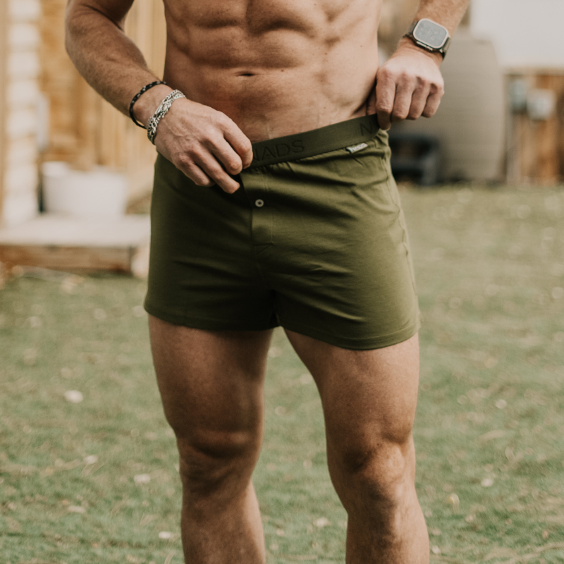 Man Standing with his hands on the waistband of an Organic Cotton Boxer in Green 
